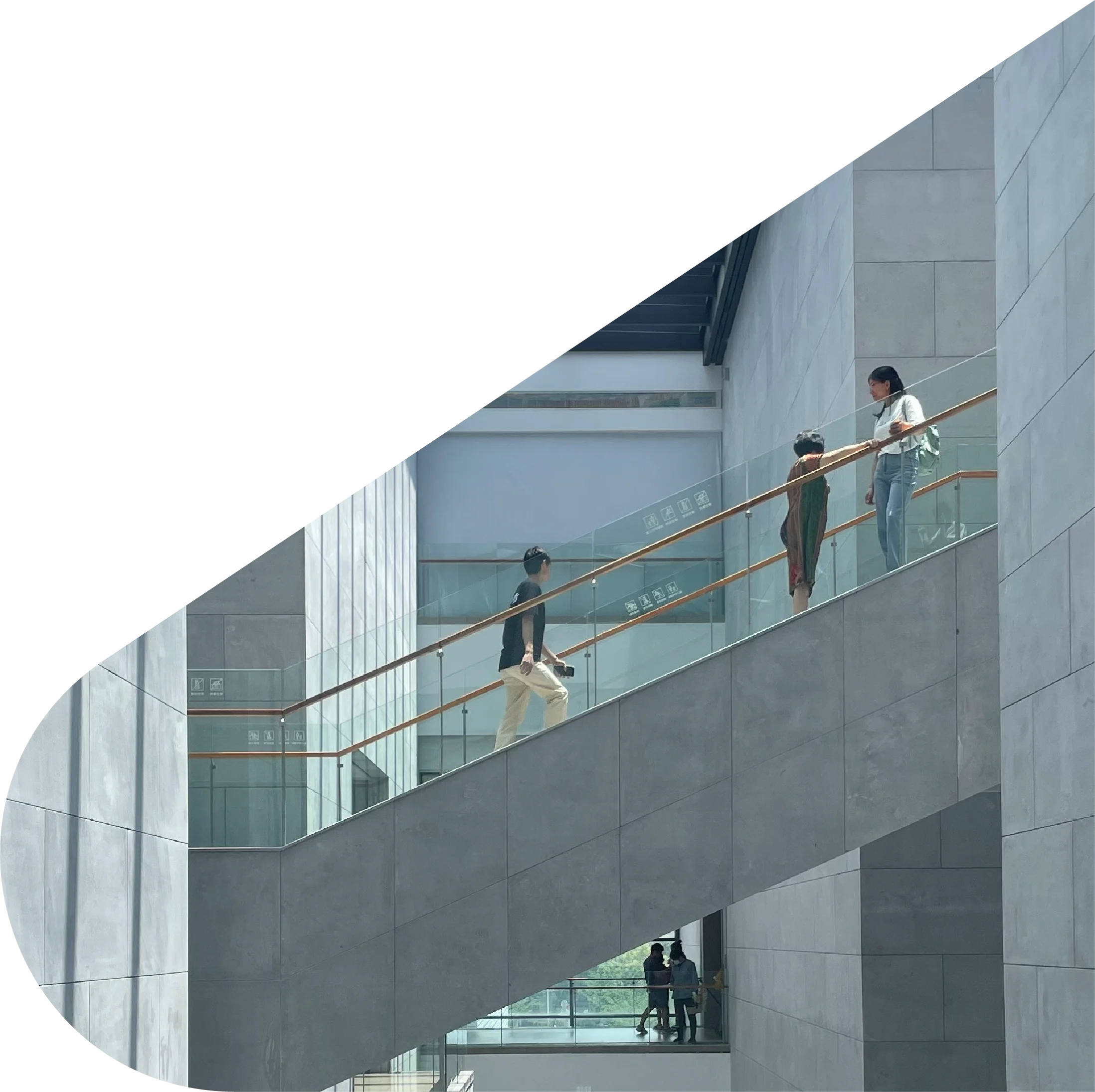 People walking through modern building symbolising financial growth, lending and investment services at Macallan Capital