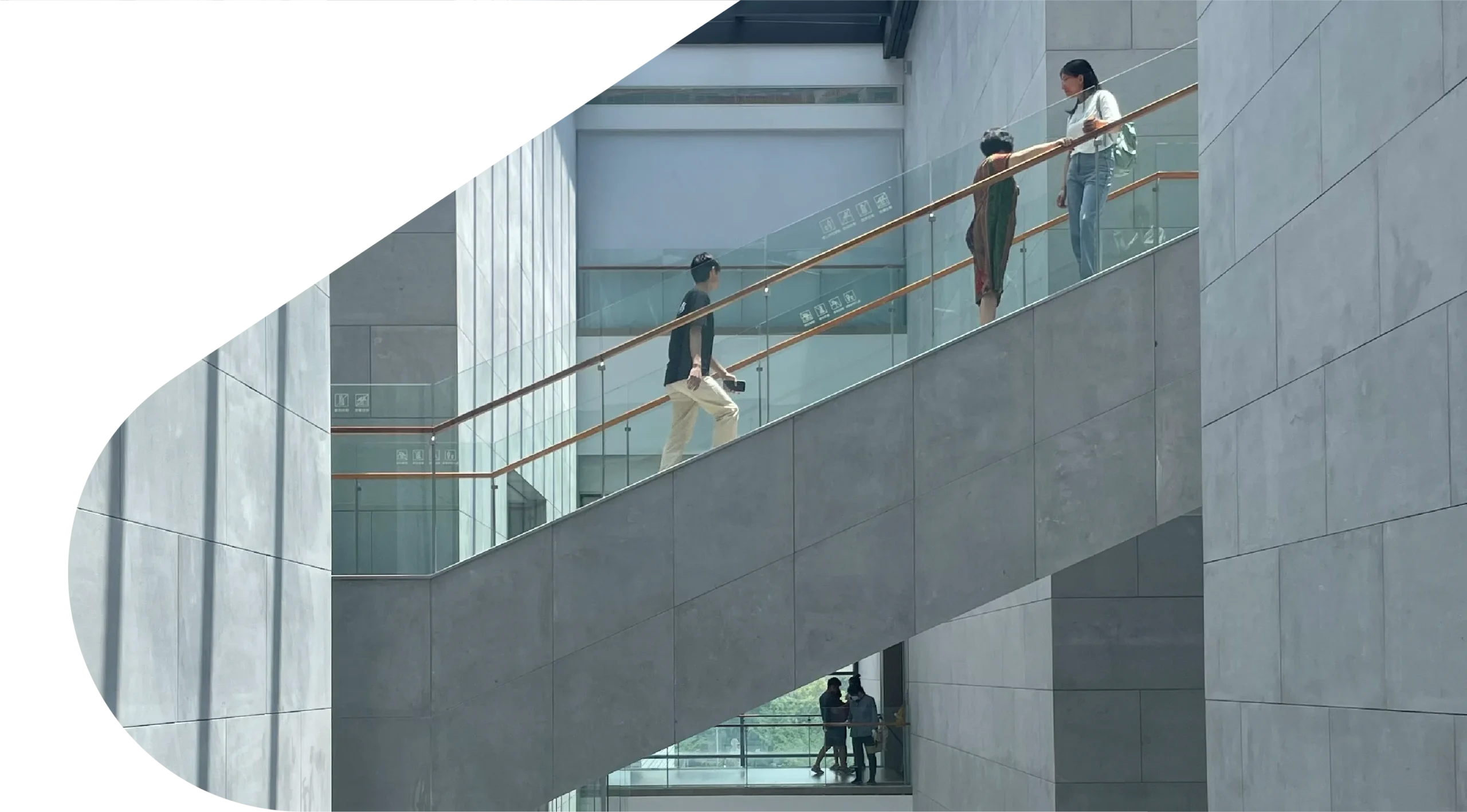 People walking through modern building symbolising financial growth, lending and investment services at Macallan Capital